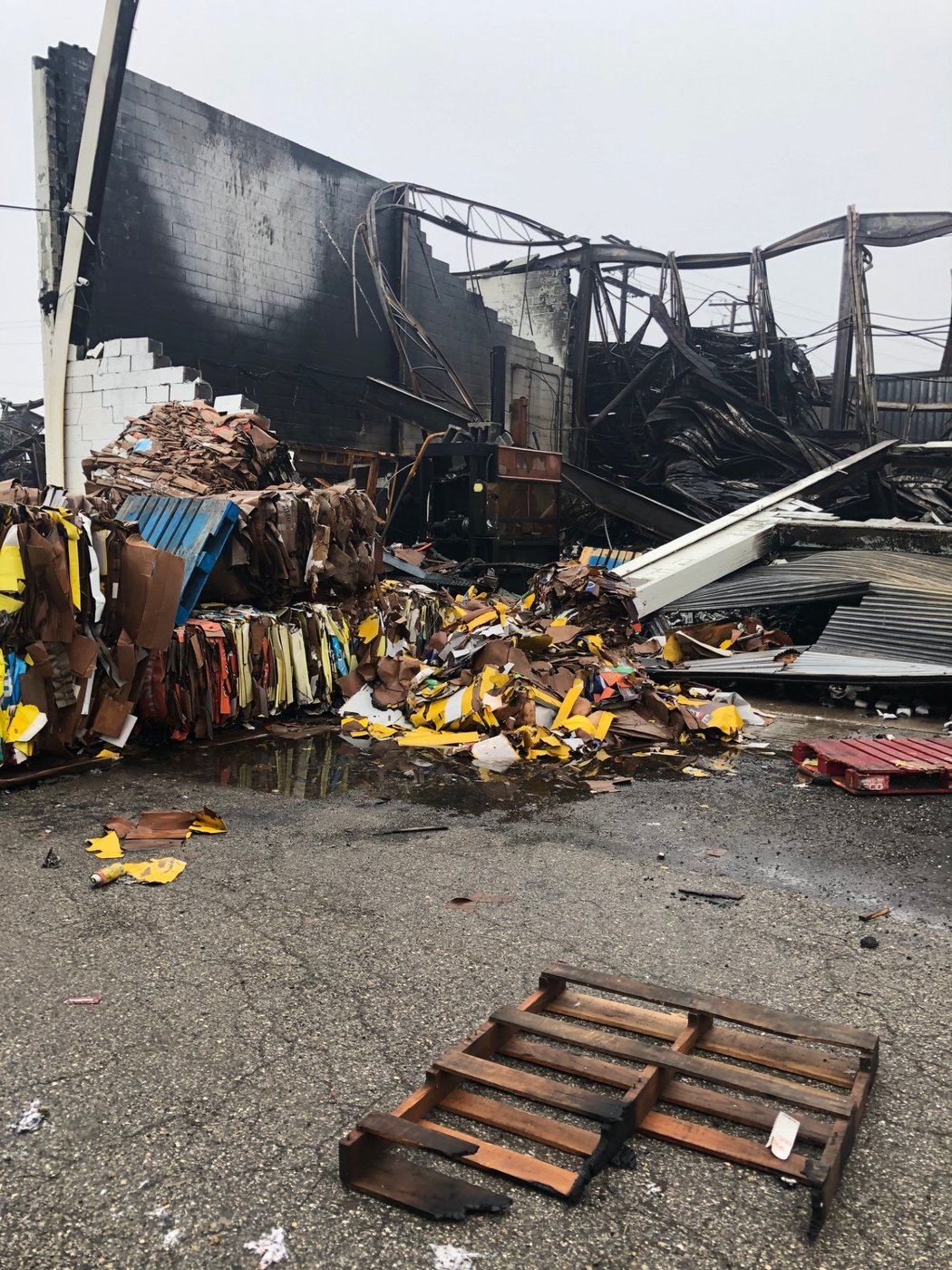 Fire-damaged commercial structure with debris