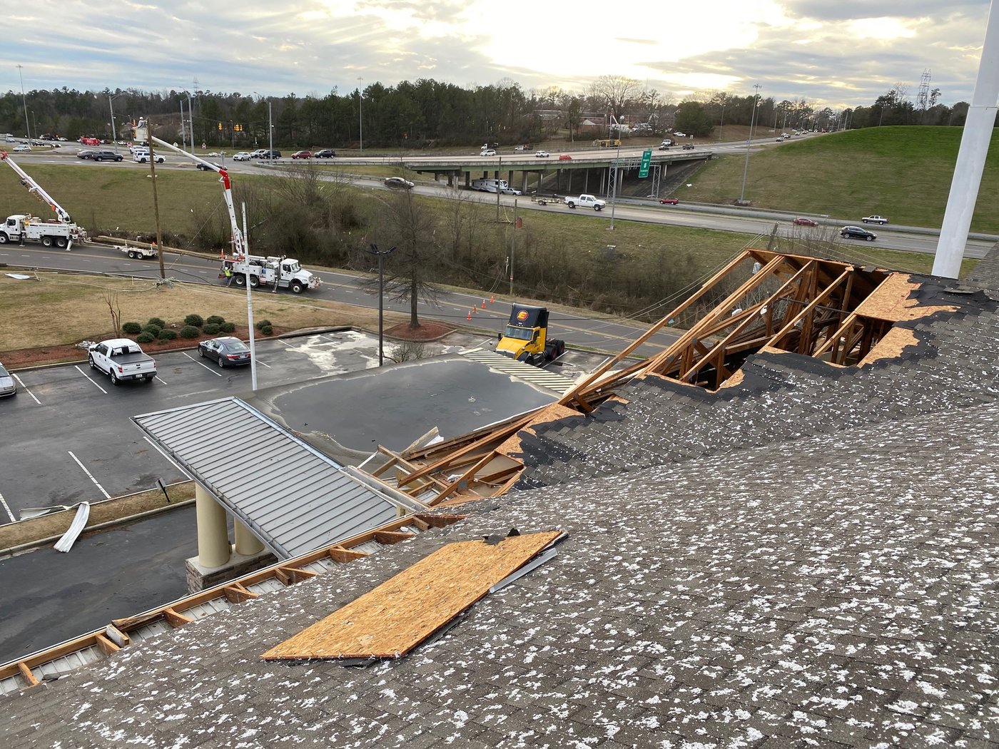 Wind-torn roofing and scattered debris